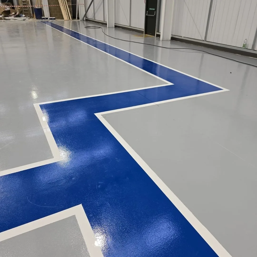 High Build Epoxy Coating - Blue Walkway through a Warehouse High Build Epoxy Coating - Blue Walkway through a Warehouse