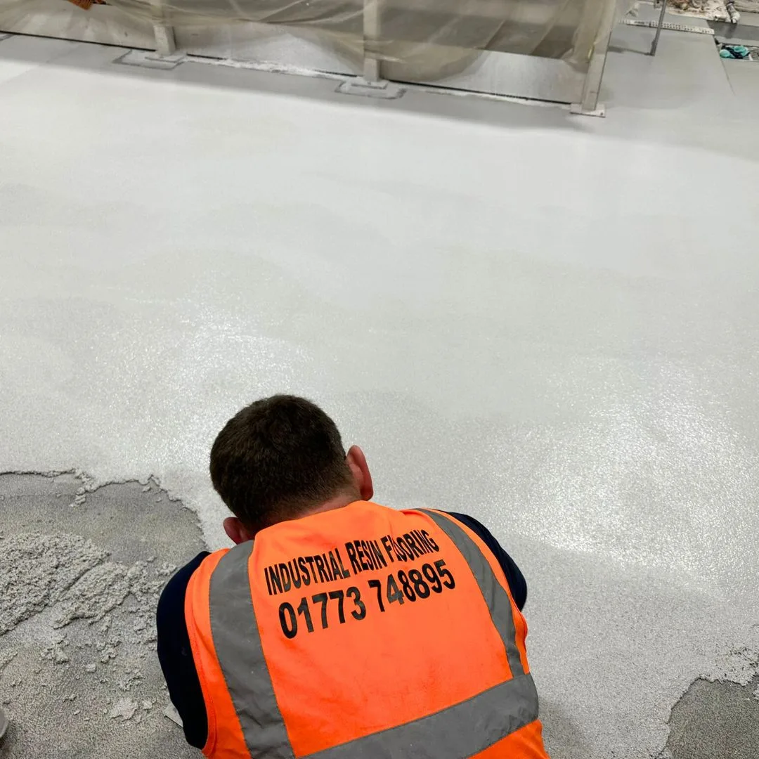 Polyurethane Cement - Industrial Resins Employee laying the floor